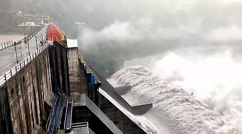 Water gushes through the opened gates of the Salal Dam as the Chenab river swells amid heavy rainfall, in Reasi district, Jammu and Kashmir, Wednesday, July 22, 2026.