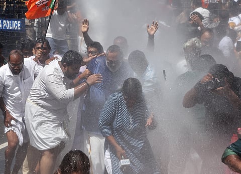 BJP state president Rajeev Chandrasekhar is helped by party workers after police used water cannons during a BJP protest in front of the KPCC headquarters in Thiruvananthapuram on Wednesday, against the Congress leaders' protest in front of the Prime Minister's residence in New Delhi on Tuesday.