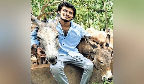 Yadhukrishna with the donkeys at his farm