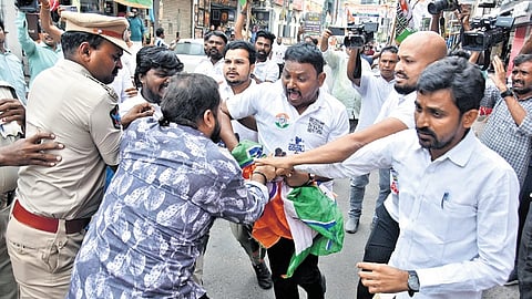 Police try to prevent a clash between Congress and BJP functionaries near Andhra Ratna Bhavan in Vijayawada on Wednesday.