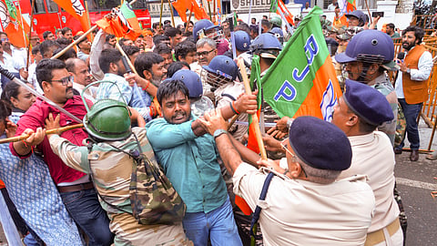  Security personnel intervene as Congress and BJP workers clash during a Congress protest outside the BJP state headquarters over the alleged NEET paper leak issue, in Ranchi, Thursday, July 23, 2026. 