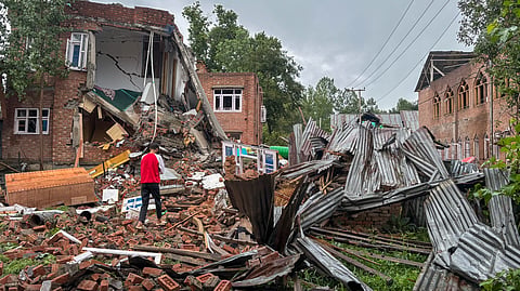 A man walks past debris after a house belonging to Adil Thokar, a Lashkar-e-Taiba (LeT) terrorist, was demolished, in Anantnag district, Jammu and Kashmir, Thursday, July 23, 2026. 