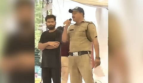 Screengrab from the viral video of the suspended Uttarakhand Police constable appearing in the Cockroach Janata Party protest at Jantar Mantar, New Delhi.