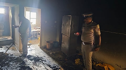 Police officials inspect the PG room where a suspected LPG cylinder explosion occurred in Hebbagodi on Thursday.