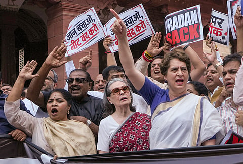 Congress MPs Sonia Gandhi and Priyanka Gandhi Vadra and other opposition leaders stage a protest as they hold placards and a black banner demanding resignation of Union Education Minister Dharmendra Paradhan over the NEET paper leak issue, during the Monsoon session of Parliament, in New Delhi, Thursday, July 23, 2026. 