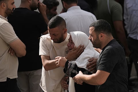 People mourn as the bodies of four Palestinians, who according to the Palestinian Health Ministry, were killed by Israeli forces near the village of Tell, arrive at Nablus Speciality Hospital in the West Bank city of Nablus, Friday, July 24, 2026.