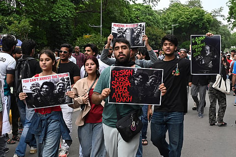 Protesters in large numbers continue their protest at Jantar Mantar in support of the Cockroach Janata Party (CJP), demanding the resignation of Union Education Minister Dharmendra Pradhan over alleged examination irregularities and NEET paper leak, in New Delhi on Thursday. 