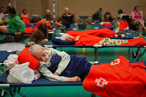 Residents spend the night at a sports center after being evacuated from their homes because of the threat of a wildfire in Cebreros, Ávila province, Spain, Friday, July 24, 2026. 
