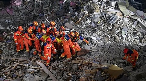 Rescue workers searching for 50 missing people in the rubble.