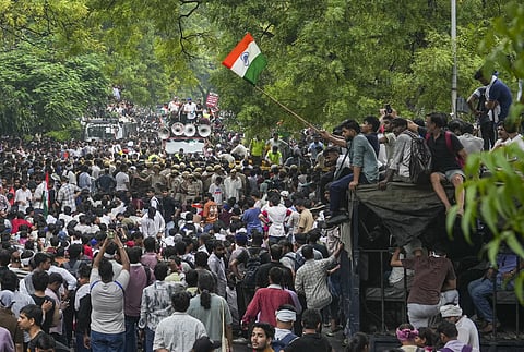 Protesters gather during a march from Jantar Mantar towards Parliament demanding the resignation of Union Education Minister Dharmendran in Delhi. 