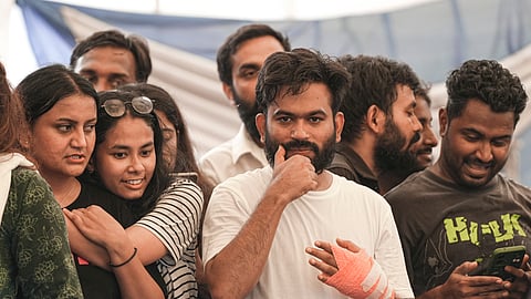 Cockroach Janta Party (CJP) founder Abhijeet Dipke, with supporters, celebrates after Union Education Minister Dharmendra Pradhan resigned and took responsibility for the NEET paper leak at Jantar Mantar in New Delhi, Saturday, July 25, 2026.