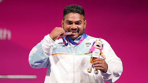 India's Jhandu Kumar celebrates after winning the bronze medal during the medal ceremony for the men's heavyweight para powerlifting event at the Commonwealth Games 2026, in Glasgow, Friday, July 24, 2026. 