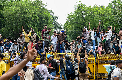 People celebrate after Union Education Minister Dharmendra Pradhan resigned and took responsibility for the NEET paper leak, at Jantar Mantar in New Delhi, Saturday, July 25, 2026. 
