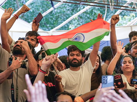 Cockroach Janta Party (CJP) Founder Abhijeet Dipke, with supporters, celebrates after Union Education Minister Dharmendra Pradhan resigned and took responsibility for the NEET paper leak, at Jantar Mantar in New Delhi, Saturday, July 25, 2026.