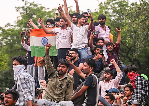 Cockroach Janta Party (CJP) supporters celebrate after Union Education Minister Dharmendra Pradhan resigned and took responsibility for the NEET paper leak, at Jantar Mantar in New Delhi, Saturday, July 25, 2026.
