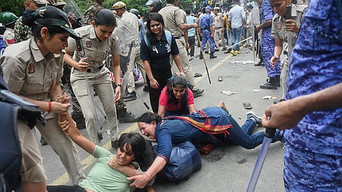 Police detain supporters of the Cockroach Janta Party as they attempt to march toward India's Parliament, demanding the resignation of the education minister, in New Delhi, Monday, July 20, 2026. 