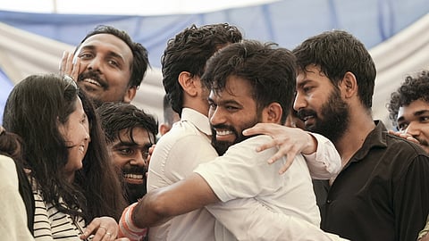 Cockroach Janta Party (CJP) founder Abhijeet Dipke celebrates with supporters after Union Education Minister Dharmendra Pradhan resigned following nationwide protests led by the party.