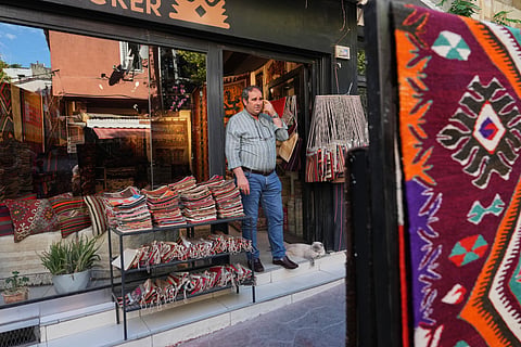 Turkish carpet merchant Ali Osman Aykul stands at the entrance of his shop as he waits for clients in Istanbul, Turkey, on Wednesday, June 17, 2026. 