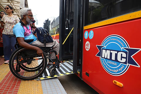 A man on wheelchair boards a bus during the ‘Near-Level Bus Boarding Trial’ held at Vivekananda House.