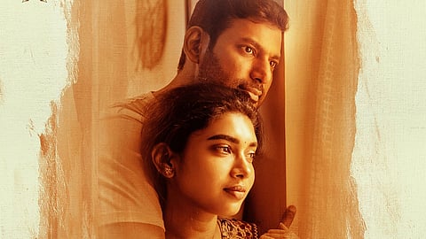 Vishal and Dushara Vijayan in a poster for Magudam