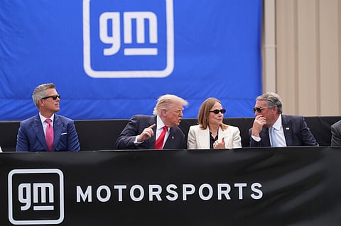 President Donald Trump, center left, speaks with Mary Barra, chair and CEO of General Motors, center right, and General Motors President Mark Reuss, right, as Transportation Secretary Sean Duffy listens at left, during a driving demonstration at General Motors proving ground, Monday, July 27, 2026, in Milford, Mich. 