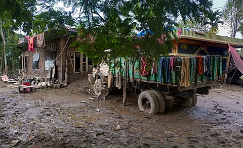 A truck stands amid mud and slush outside flood-affected houses at Nazira, in Sivasagar, Assam, Monday, July 27, 2026