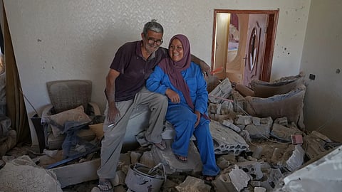 Mahasen Faqih, and her husband, Mohammed Sobeih, smile as they sit amid the rubble of their home after returning to it following the Israeli military operation in Zawtar al-Gharbieh, Lebanon, Tuesday, July 28, 2026.