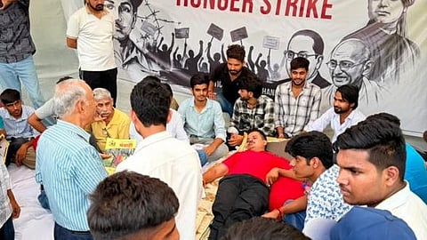 Rewar has pitched a tent outside the campus gate and is staging a sit-in protest alongside four dozen supporters
