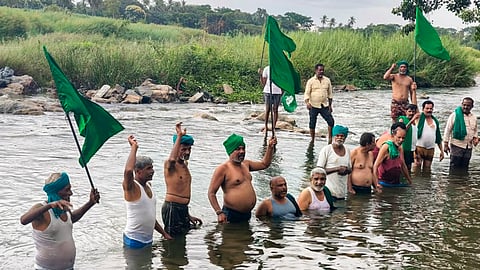 People stage a protest over the CWMA upholding the CWRC order to release 3,500 cusecs of Cauvery water daily to Tamil Nadu for the next 15 days, in Mandya, Karnataka, Thursday, July 30, 2026.