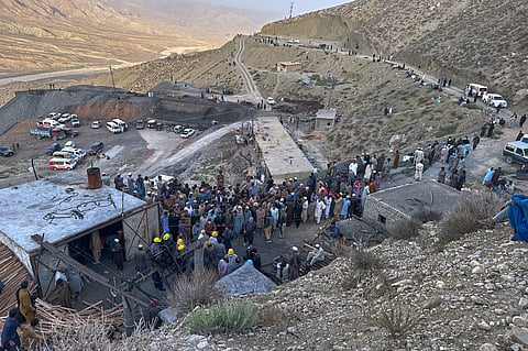 People gather as rescue workers attempt to reach miners trapped in a coal mine on the outskirts of Quetta, the capital of Baluchistan province, in southwest Pakistan, Thursday, July 30, 2026.