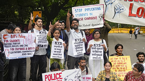 Demonstrators hold placards during a protest against the police crackdown on students and youth over the NEET paper leak issue, at Jantar Mantar