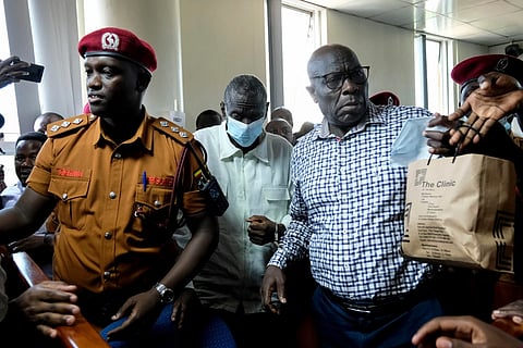Ugandan opposition leader and four-time presidential candidate Kizza Besigye, second left centre, arrives in a civilian court in Kampala, Uganda on Feb. 19, 2025.