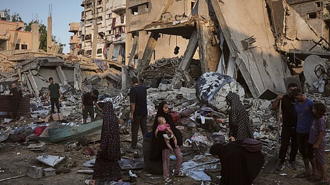 Palestinians salvage their belongings from the rubble of a building and tents destroyed in an Israeli airstrike in Gaza City, Thursday, July 30, 2026.