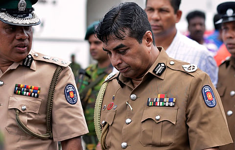 Sri Lankan police chief Pujith Jayasundara, right, leaves after an inspection at St. Anthony's church, one of the sites of Easter Sunday explosions in Colombo, Sri Lanka, April 21, 2019.