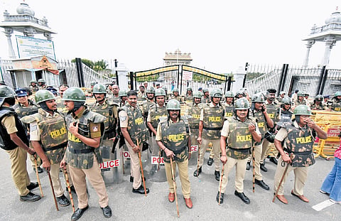 Police stand guard outside the Krishna Raja Sagar resrvoir in Mandya district ahead of the protest by BJP  