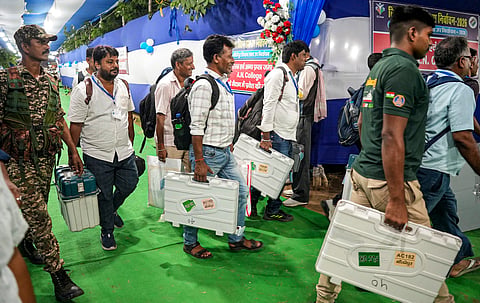  Security personnel escort polling officials with EVMs and VVPATs after voting in the Bankipur assembly by-poll, in Patna, Thursday, July 30, 2026.