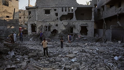 Palestinians inspect the rubble of a building destroyed in an Israeli airstrike in Deir al-Balah, central Gaza Strip, Wednesday, July 29, 2026. 