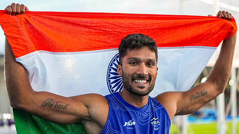 India's Tejaswin Shankar celebrates with the national flag after winning the bronze medal in the men's decathlon event at the Commonwealth Games 2026, in Glasgow, Scotland, Friday, July 31, 2026.