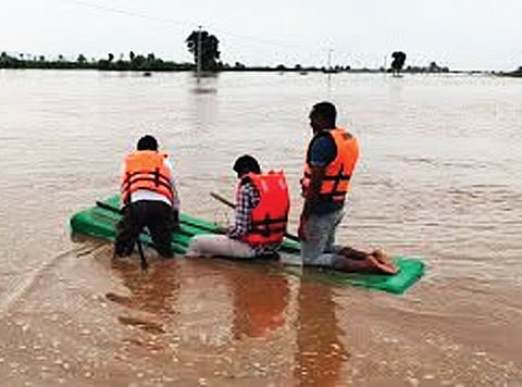 A man stranded on a sandbank in Charla mandal being rescued