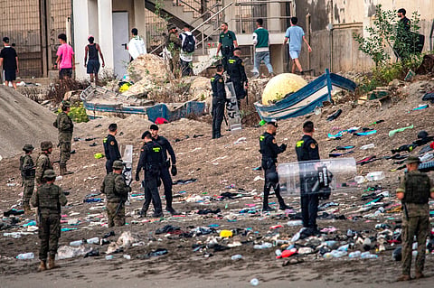 Spanish army soldiers and Guardia Civil officers stand guard as migrants return to Morocco from the Spanish enclave of Ceuta, Saturday, Aug. 1, 2026.