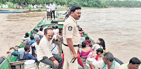 Residents of Godavari island villages being evacuated near Rajamahendravaram; the water level in the Godavari river at Sir Arthur Cotton Barrage in Dowleswaram.