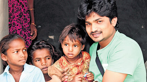 Santosh Bogan, founder of People Helping Children (PHC), interacts with students from bridge schools in Mulugu district