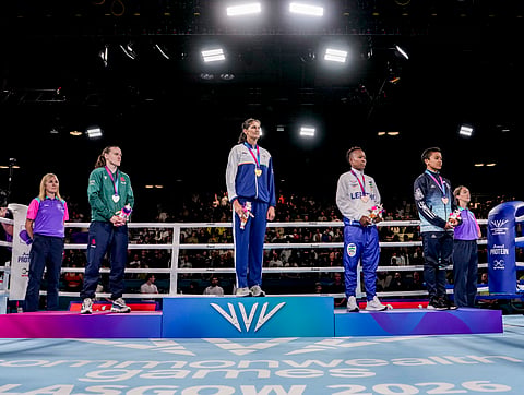 Jaismine Lamboria stands atop the podium after her victory on Saturday