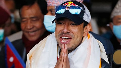Nirmal Purja, one of the team member of the all-Nepalese mountaineering team that became the first to scale Mount K2 in winter, gestures as the team arrives at Tribhuwan International airport in Kathmandu, Nepal, Jan. 26, 2021. 