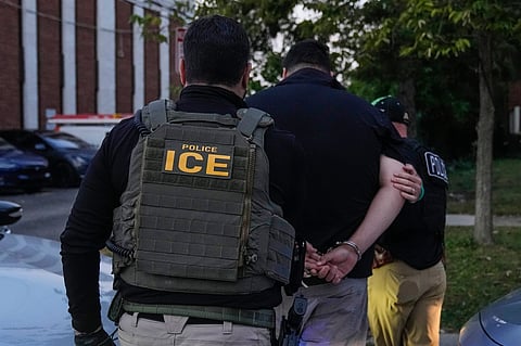 FILE - U.S. Immigration and Customs Enforcement agents make an arrest during an early morning operation in Park Ridge, Ill., Sept. 19, 2025.