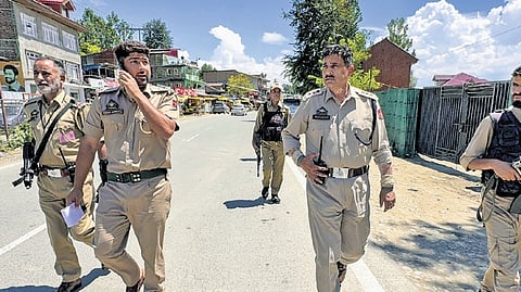 Police personnel along the Jammu-Srinagar National Highway on Sunday 