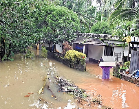 Residents shifting their belongings to relief camps after their homes were flooded due to heavy rain at Kannadikkal in Kozhikode on Sunday 