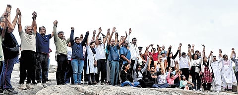 Environmentalists and volunteers form a human chain in protest against the tunnel road project at Lalbagh in Bengaluru on Sunday, August 2, 2026.