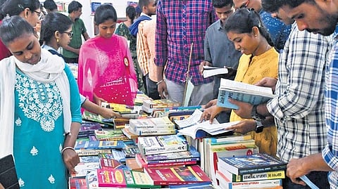 Book enthusiasts take books at the free book distribution event at the Sarvottama Grandhalayam in Vijayawada. 