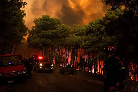 Greek firefighters try to extinguish a wildfire in the area of Porto Germeno, some 70 kilometres (45 miles) northwest of Athens in the region of Viotia, on August 1, 2026.